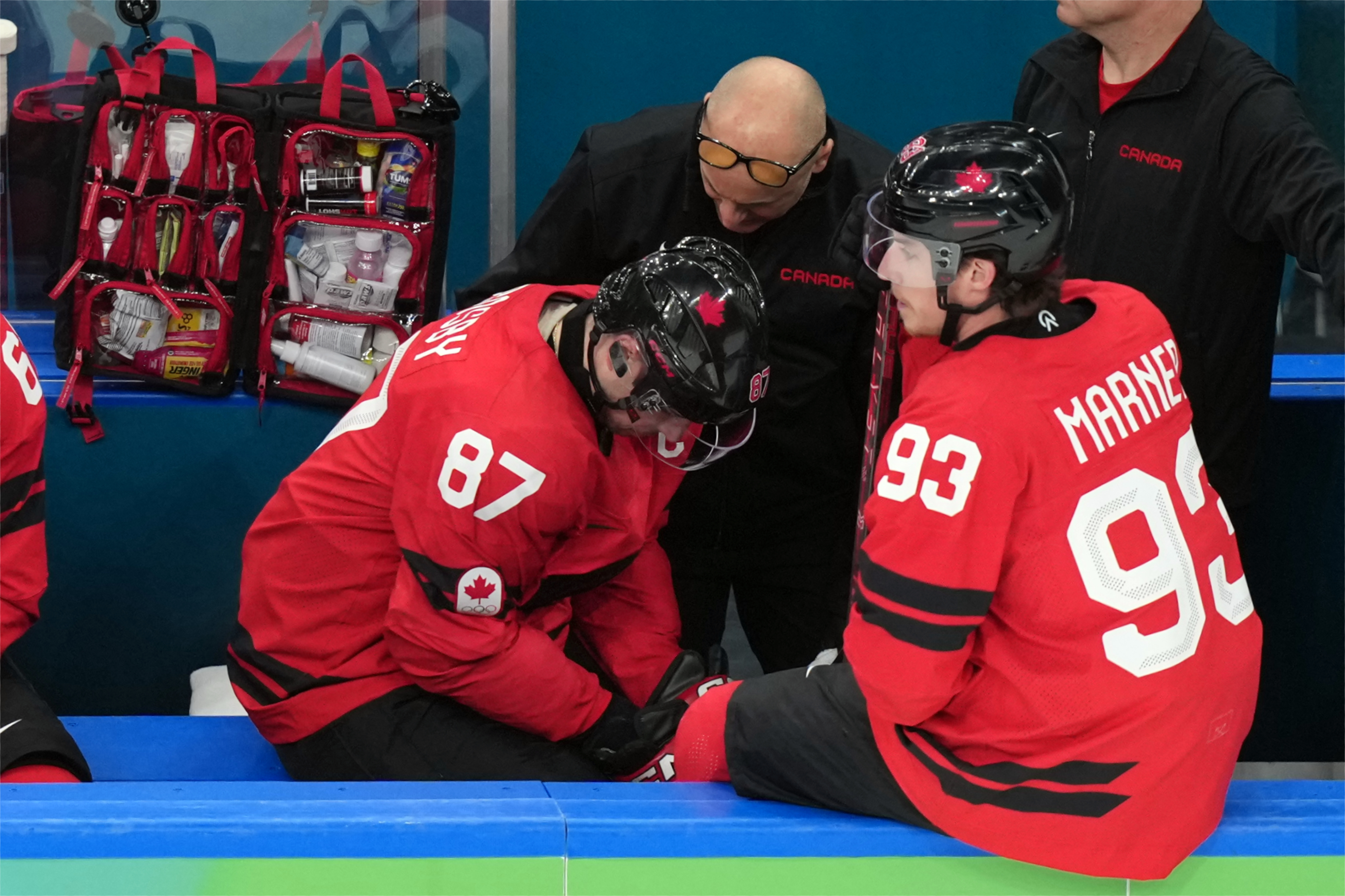 Canada's Sidney Crosby (87) is attended to after being injured during the second period of a men's ice hockey quarterfinal game between Canada and Czechia at the 2026 Winter Olympics, in Milan, Italy, Wednesday, Feb. 18, 2026. 
