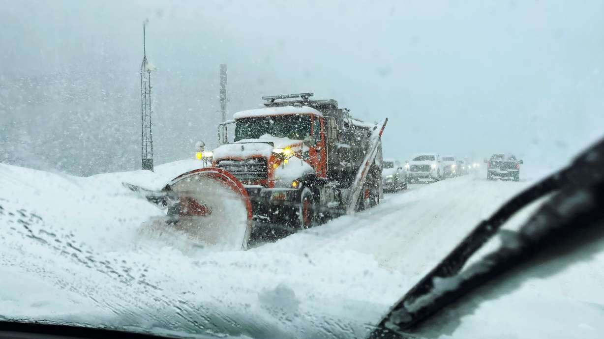 A snowplow clears the road in Big Cottonwood Canyon as snow falls along state Route 190 in Cottonwood Heights on Feb. 18. The area could get another 1 to 2 feet of snow as storms return to Utah this week.