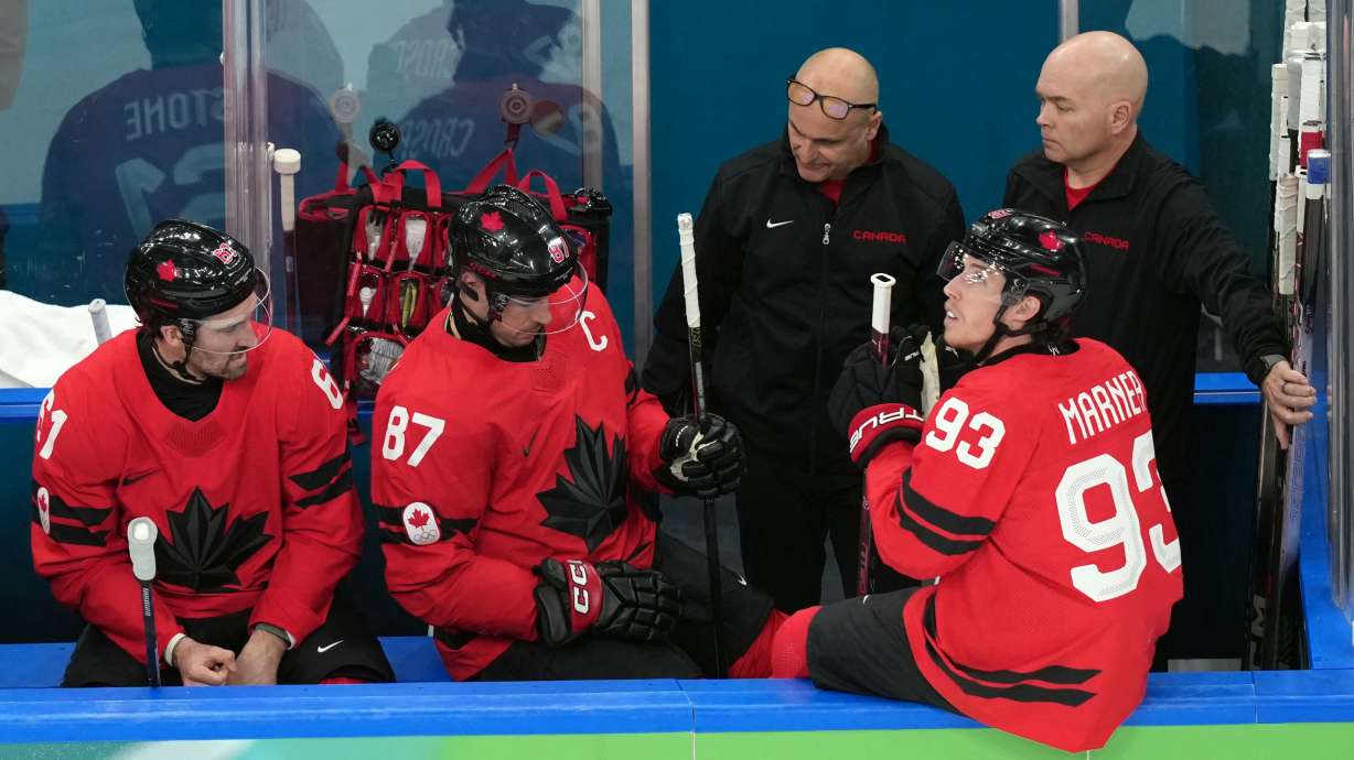 Canada's Sidney Crosby (87) is attended to after being injured during the second period of a men's ice hockey quarterfinal game between Canada and Czechia at the 2026 Winter Olympics, in Milan, Italy, Wednesday, Feb. 18, 2026.