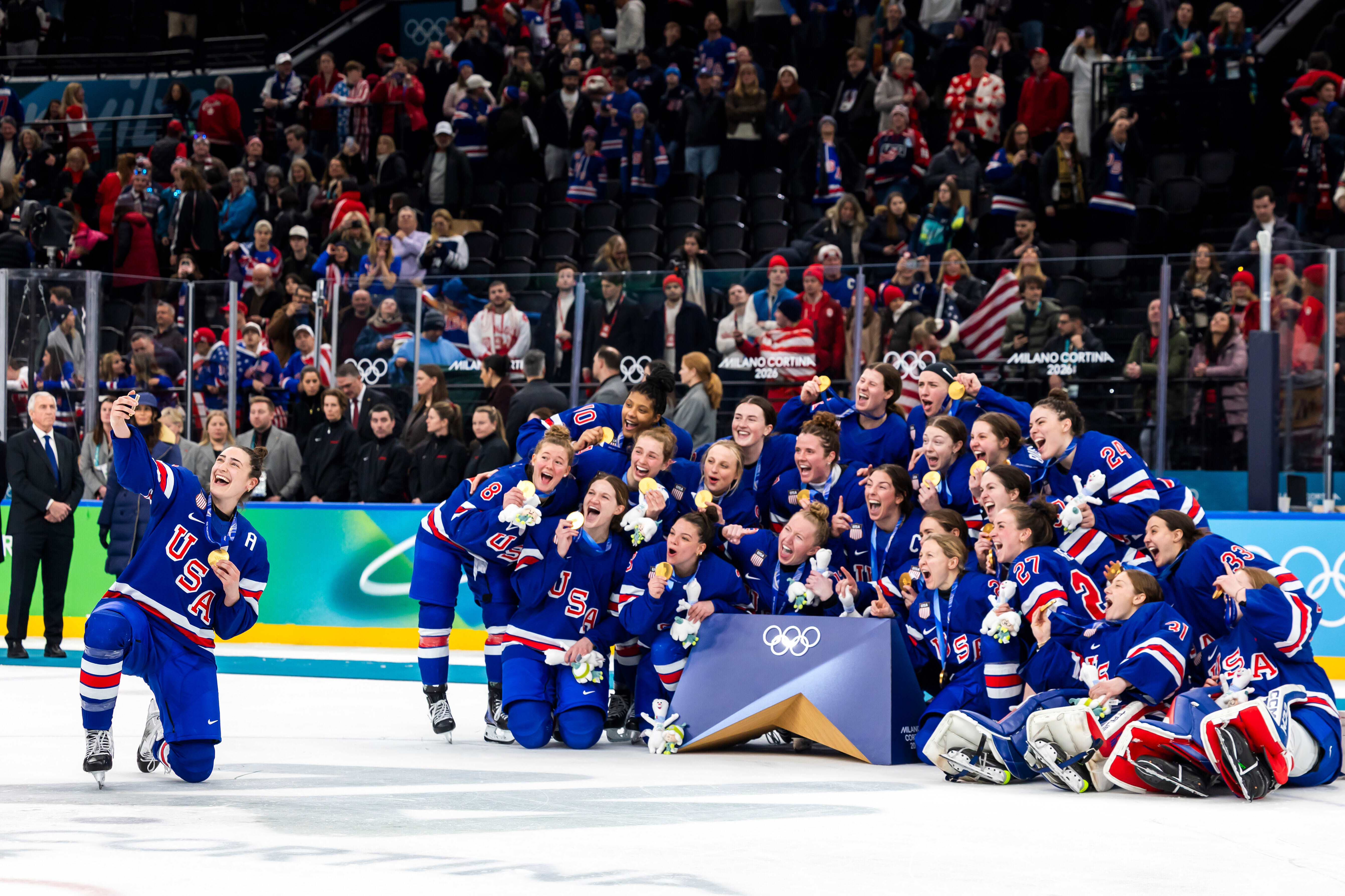 United States' Megan Keller, left, who scored the game winning goal in overtime, takes a selfie with teammates as they celebrate after defeating Canada in the women's ice hockey gold medal game at the 2026 Winter Olympics in Milan, Italy, Thursday, Feb. 19, 2026.