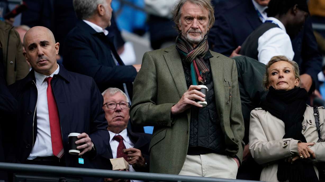 FILE - Manchester United co-owner Jim Ratcliffe stands in front of the former manager Alex Ferguson during the Premier League soccer match between Manchester City and Manchester United in Manchester, England, on Sept. 14, 2025.