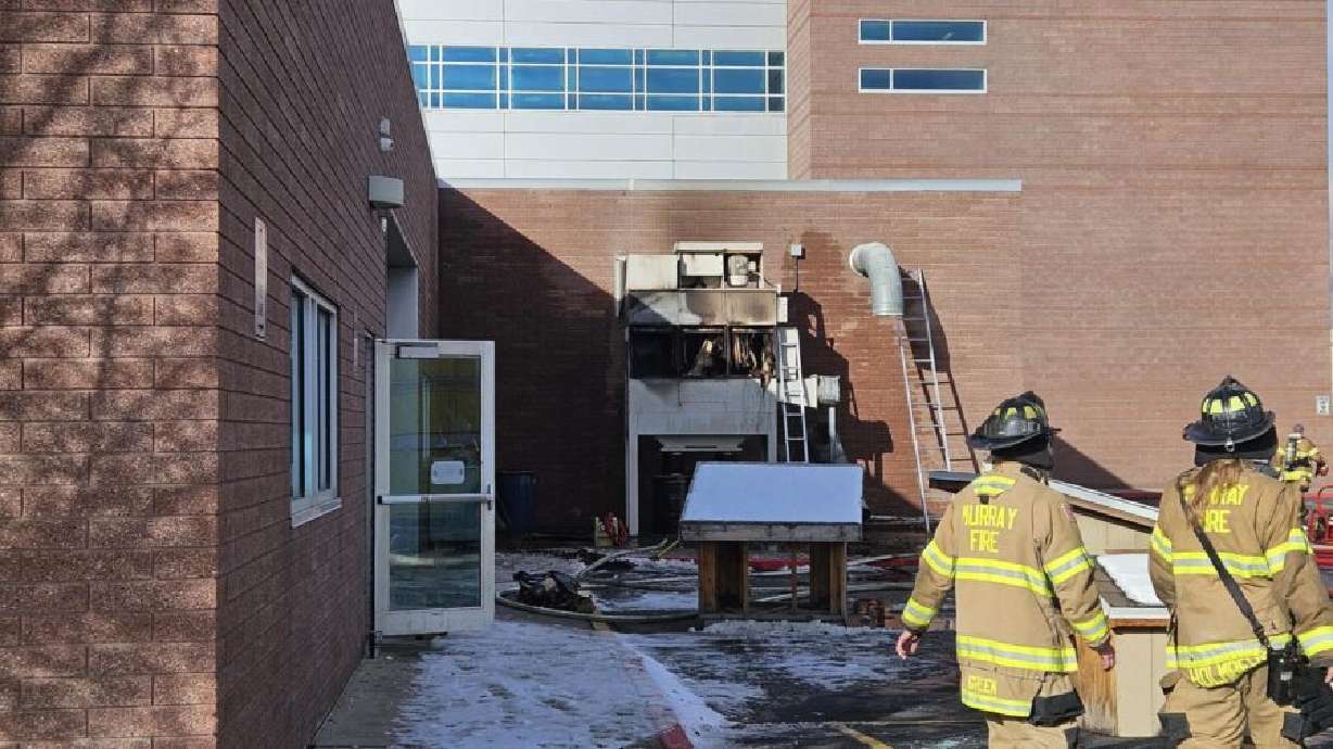 Emergency crews respond to a fire at Murray High School Friday morning. The school was evacuated due to a fire in the school's wood shop. Classes next week will be held remotely while crews repair and clean the school.