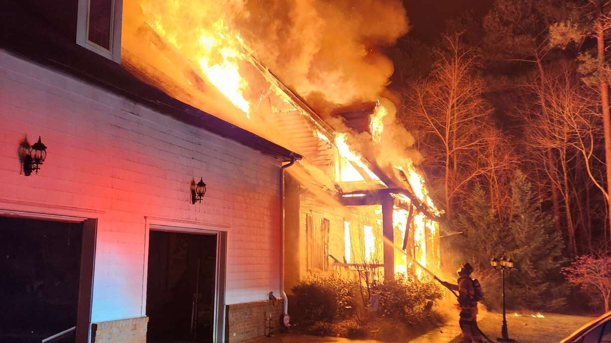 FILE - This photo provided by Lucia-Riverbend Fire Department shows firefighters battling a house fire, Dec. 28, 2025, in Stanley, N.C.