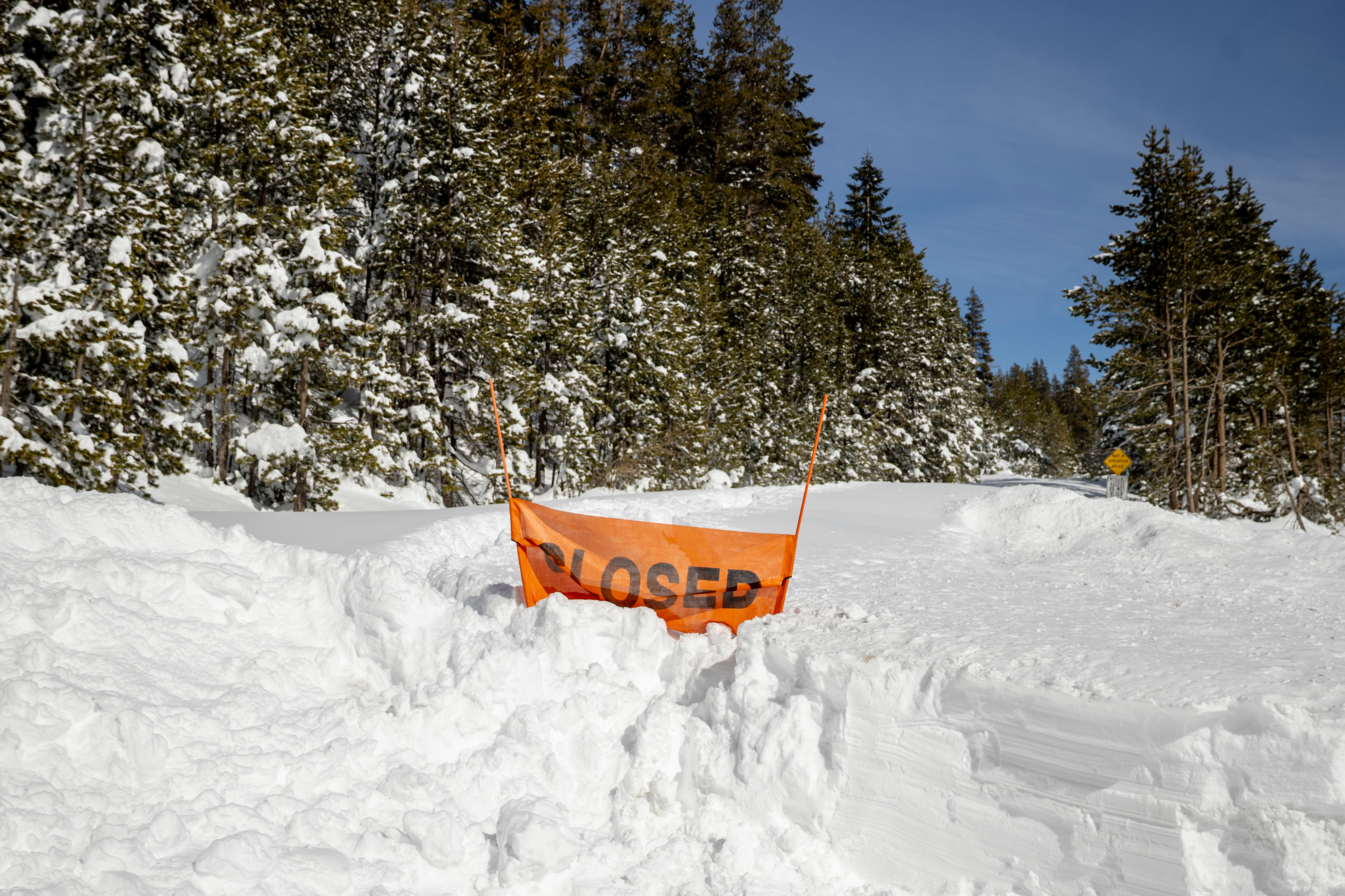 A closed sign is partially buried at the entrance to the Castle Peak trailhead in Soda Springs, Calif., Friday, Feb. 20, 2026. 