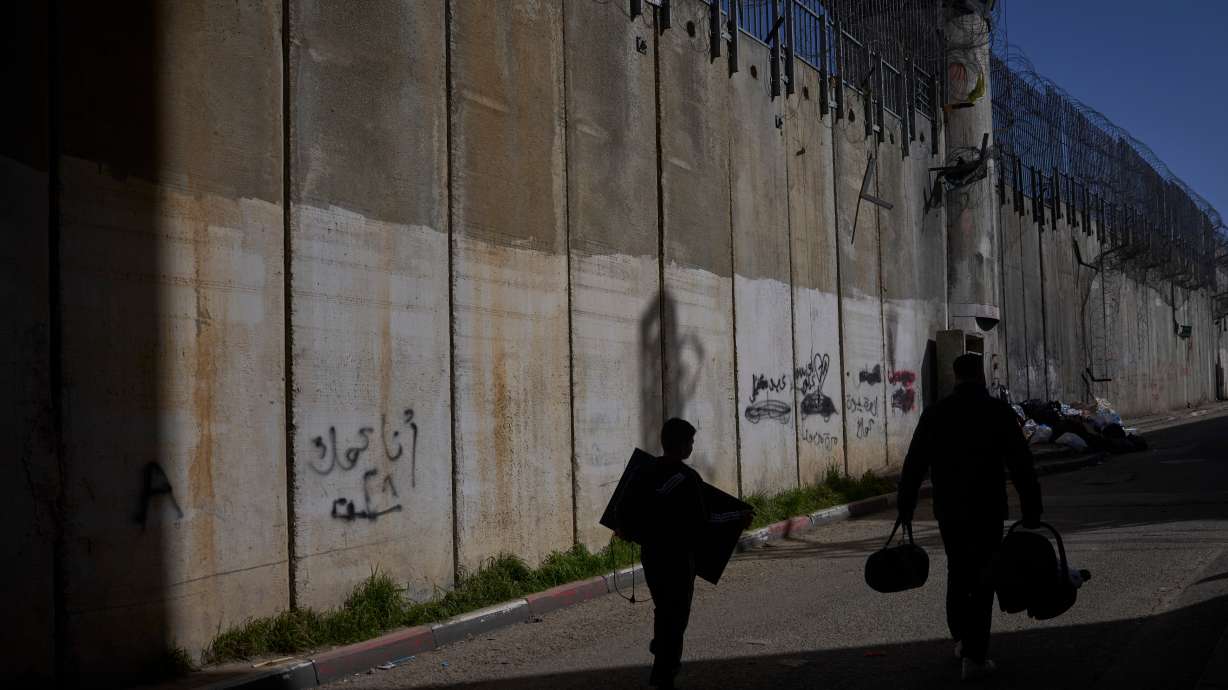 Palestinians along the barrier between the West Bank and Jerusalem neighborhood of Beit Hanina, Feb. 15. Arab and Muslim nations Saturday condemned comments by the U.S. ambassador to Israel, who said Israel has a right to much of the Middle East.