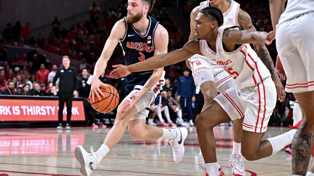 Arizona guard Anthony Dell'orso (3) controls the ball as Houston guard Mercy Miller (25) defends during the first half of an NCAA college basketball game, Saturday, Feb. 21, 2026, in Houston.