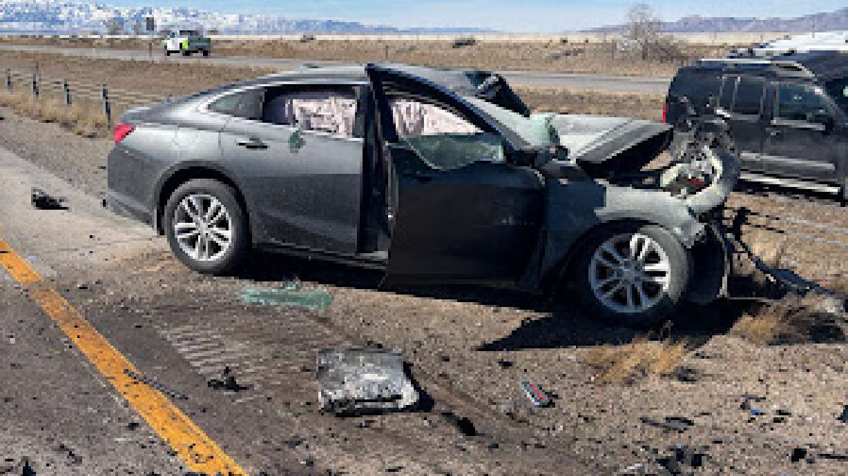 The remnants of a car involved in a fatal collision on I-80 in Magna on Saturday. One person died at the scene, while the other occupants were taken via medical helicopter and ambulance to a hospital, all in critical condition, Utah Highway Patrol said.