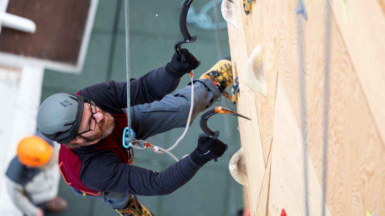 Shane Ellis makes his way up the dry tooling wall at the Millcreek Common in Millcreek on Feb. 16.