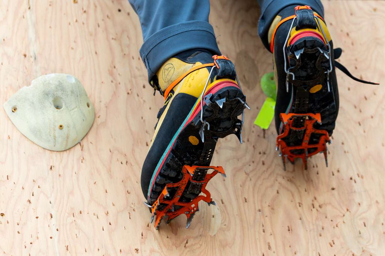 A climber makes their way up the dry tooling wall at the Millcreek Common in Millcreek on Feb. 16.
