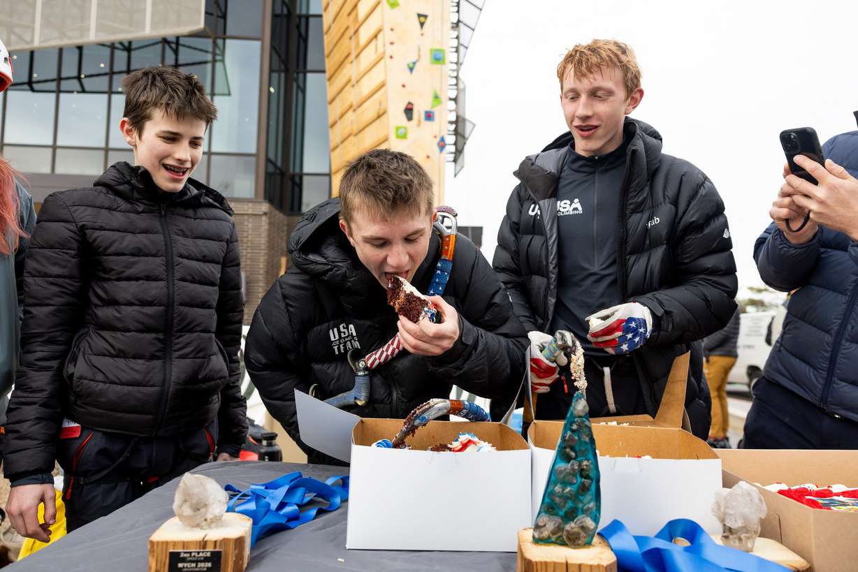 Conner Bailey, center, takes a bite of cake as the members of the USA Youth Ice Climbing team celebrate their success at the UIAA Ice Climbing World Youth Championships before an outdoor dry tooling clinic hosted by The Scratch Pad at the Millcreek Common in Millcreek on Feb. 16.