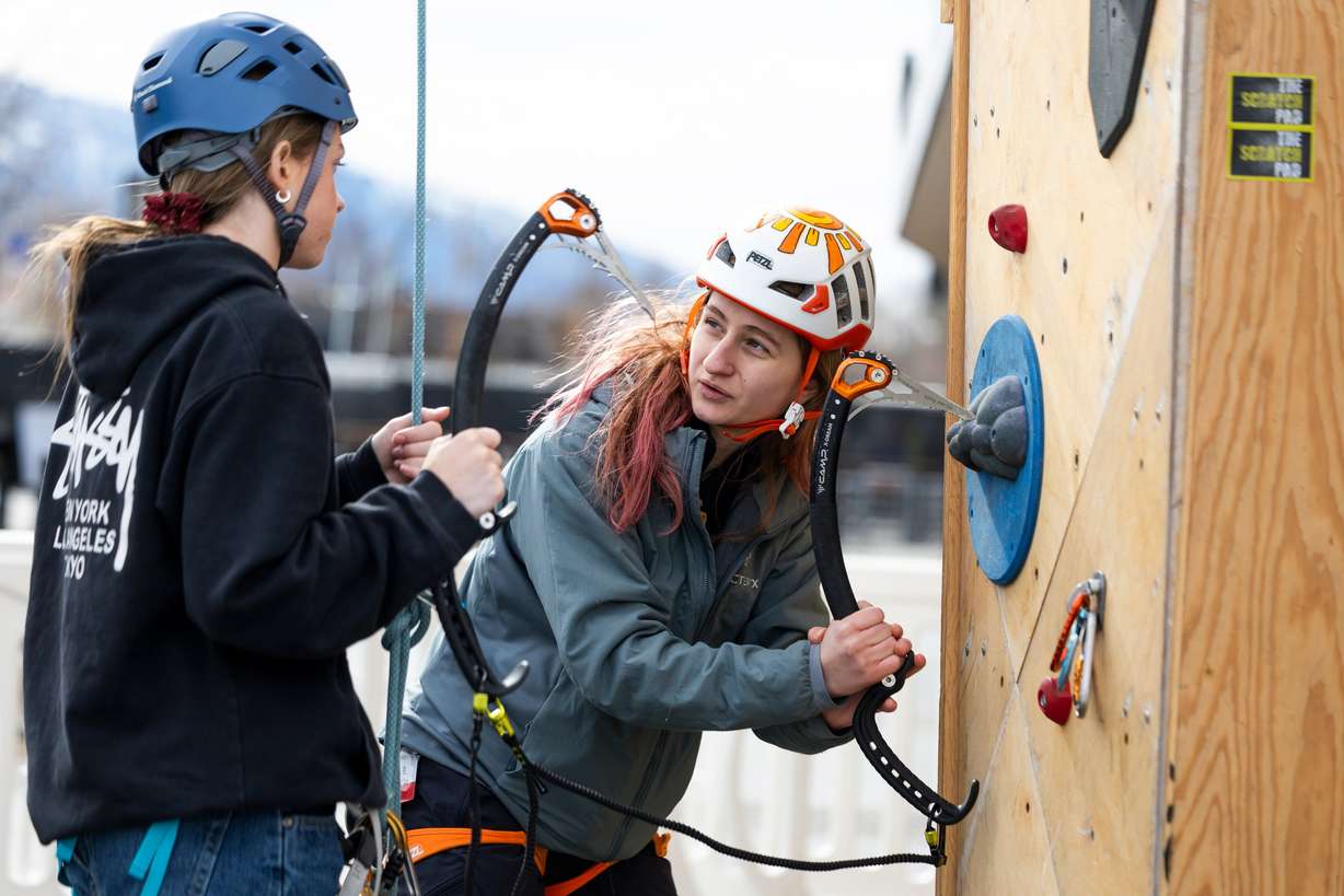 Nina Mankouski, right, teaches Sadie Batman, left, how to use an ice tool during a dry tooling clinic hosted by The Scratch Pad at the Millcreek Common in Millcreek on Feb. 16.