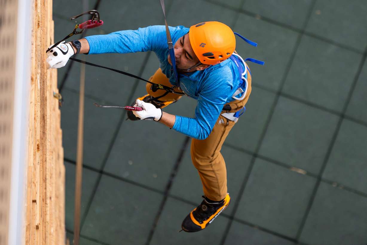 A climber falls while attempting the speed wall at the Millcreek Common in Millcreek on Feb. 16.
