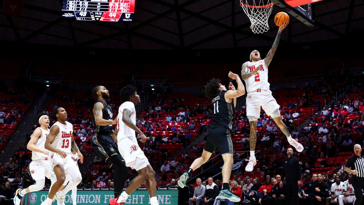 Utah guard Terrence Brown (2) drives to the basket for a layup against UCF Knights guard Carmelo Pacheco (11) during the second half of the game at the Huntsman Center in Salt Lake City on Saturday, Feb. 21, 2026.