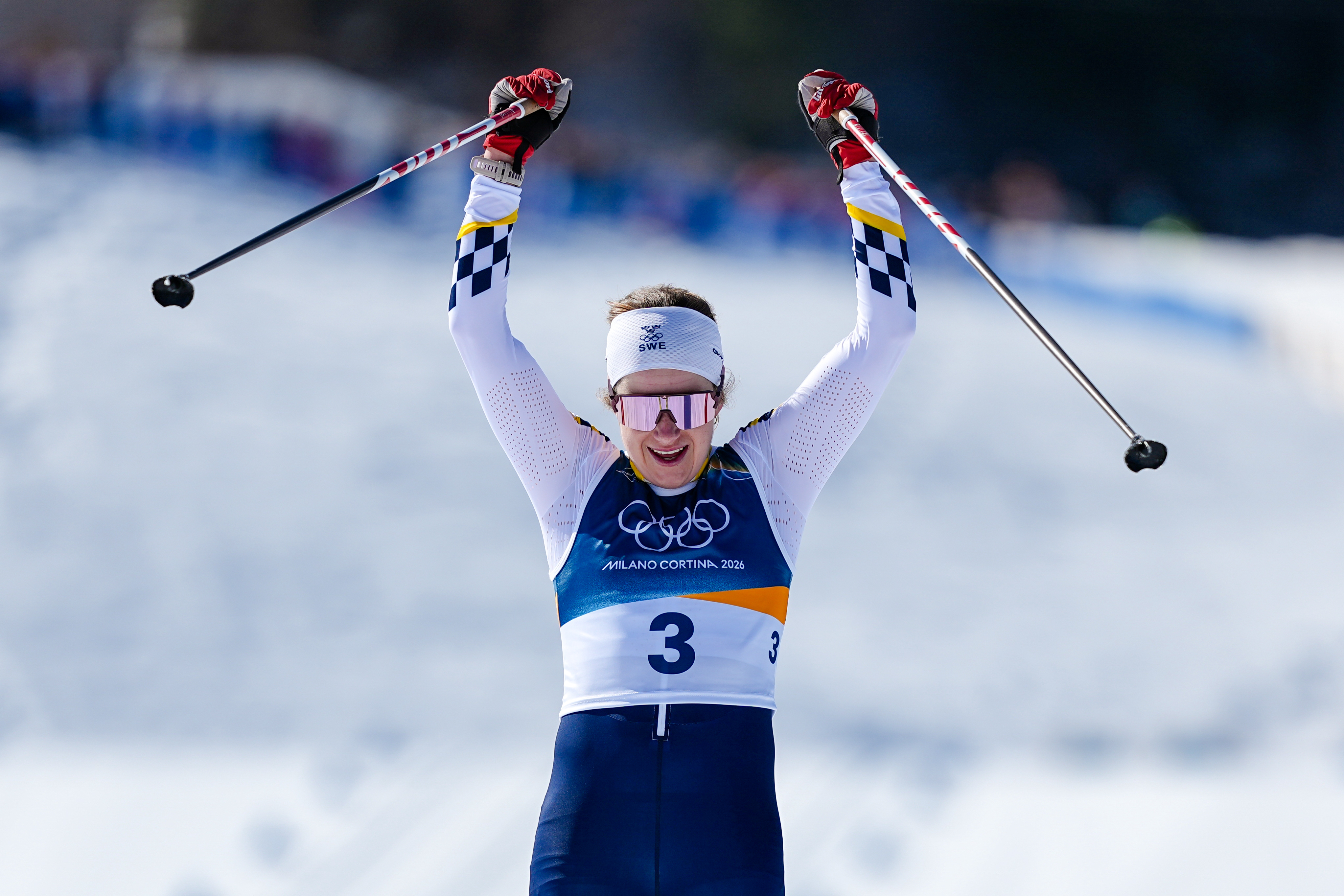 Ebba Andersson, of Sweden, crosses the finish line to win the gold medal in the cross country skiing women's 50km mass start classic at the 2026 Winter Olympics, in Tesero, Italy, Sunday, Feb. 22, 2026.