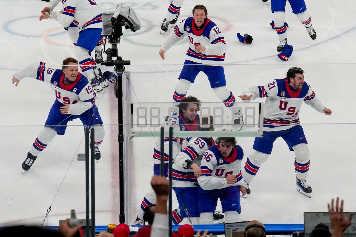 The United States celebrates after a sudden-death overtime goal by United States' Jack Hughes (86) against Canada during the men's ice hockey gold medal game at the 2026 Winter Olympics, in Milan, Italy, Sunday.