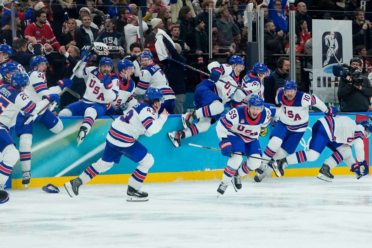 United States celebrate after defeating Canada in a men's ice hockey gold medal game between Canada and the United States at the 2026 Winter Olympics, in Milan, Italy, Sunday.