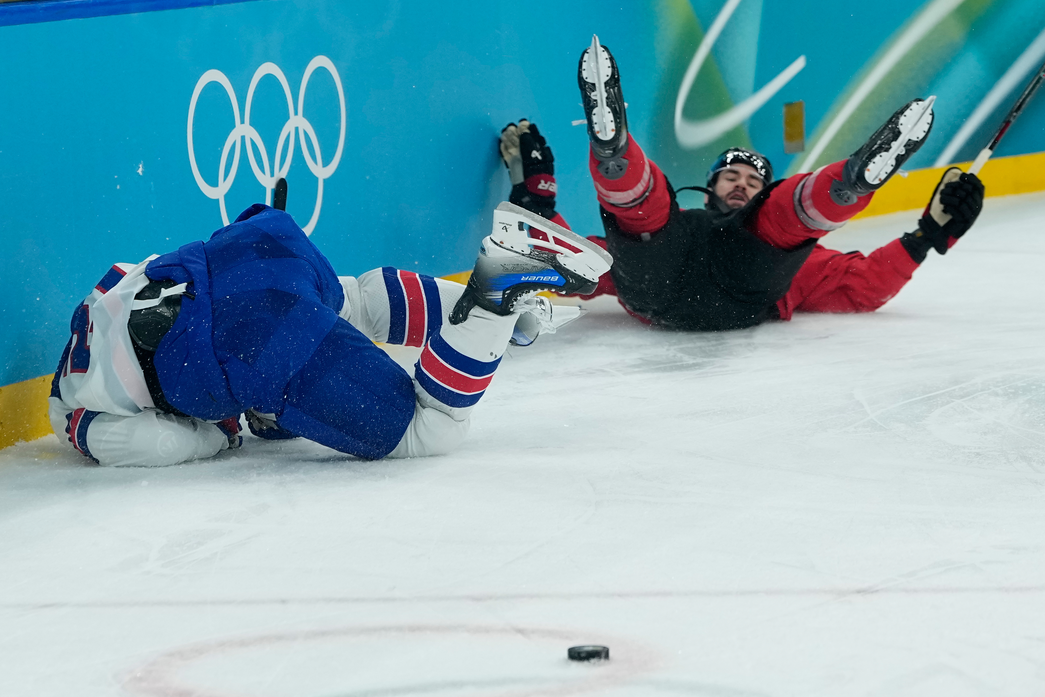 United States' Dylan Larkin (21), left, and Canada's Tom Wilson (43) collide during the first period of a men's ice hockey gold medal game between Canada and the United States at the 2026 Winter Olympics, in Milan, Italy, Sunday.