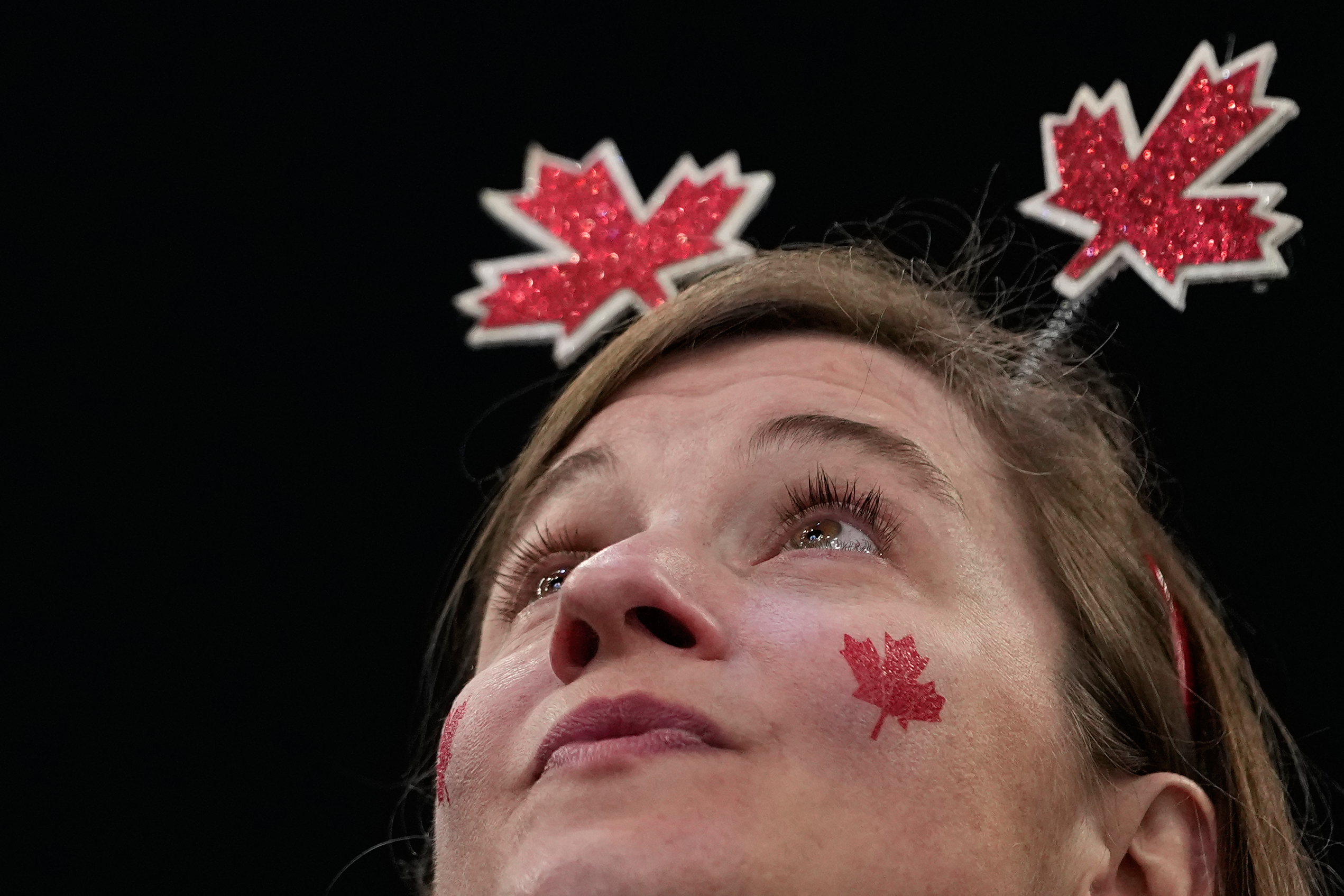 A supporter cheers before a men's ice hockey gold medal game between Canada and the United States at the 2026 Winter Olympics, in Milan, Italy, Sunday.