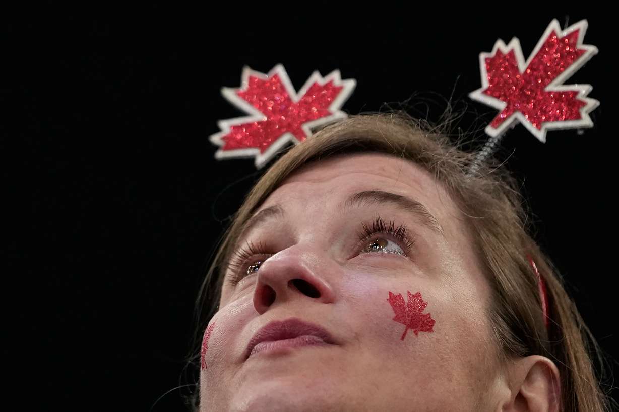 A supporter cheers before a men's ice hockey gold medal game between Canada and the United States at the 2026 Winter Olympics, in Milan, Italy, Sunday.