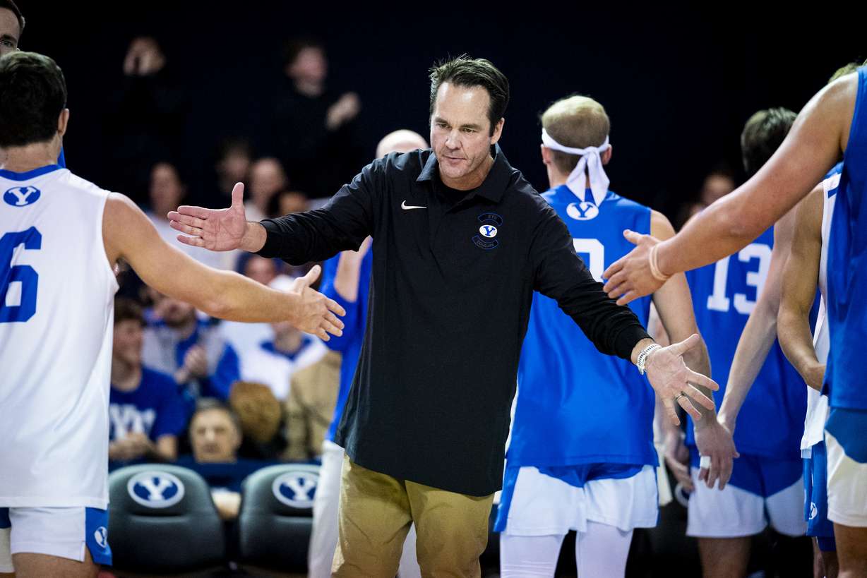 BYU head coach Shawn Olmstead slaps hands with his players as a timeout is taken during an NCAA men’s volleyball game against UC San Diego held at the George Albert Smith Fieldhouse in Provo on Friday, Jan. 16, 2026.