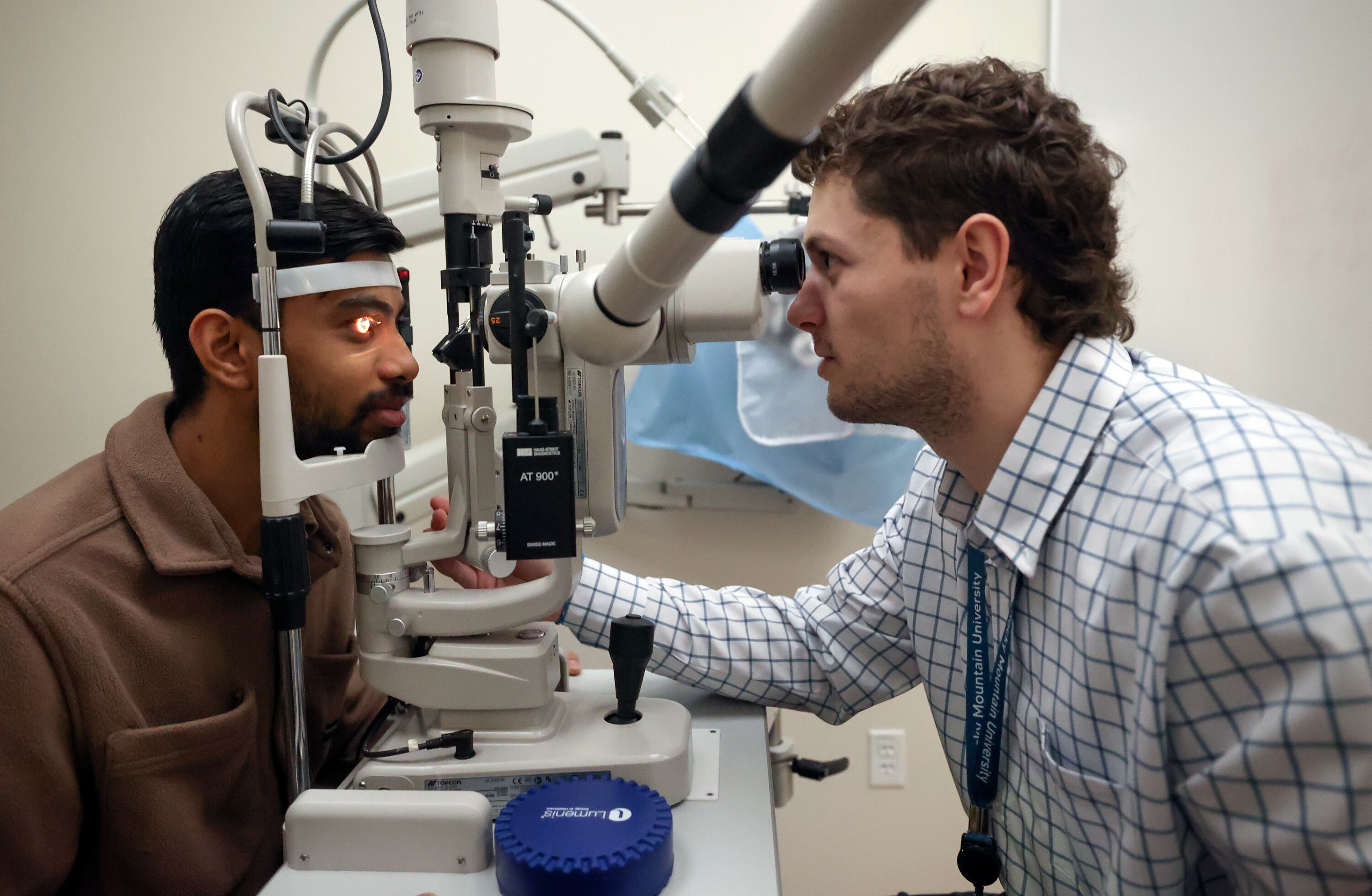 Second-year doctor of optometry student Coleby Hess, right, checks the cornea of fellow second-year student Parth Patel at Rocky Mountain University in Provo on Jan. 14.