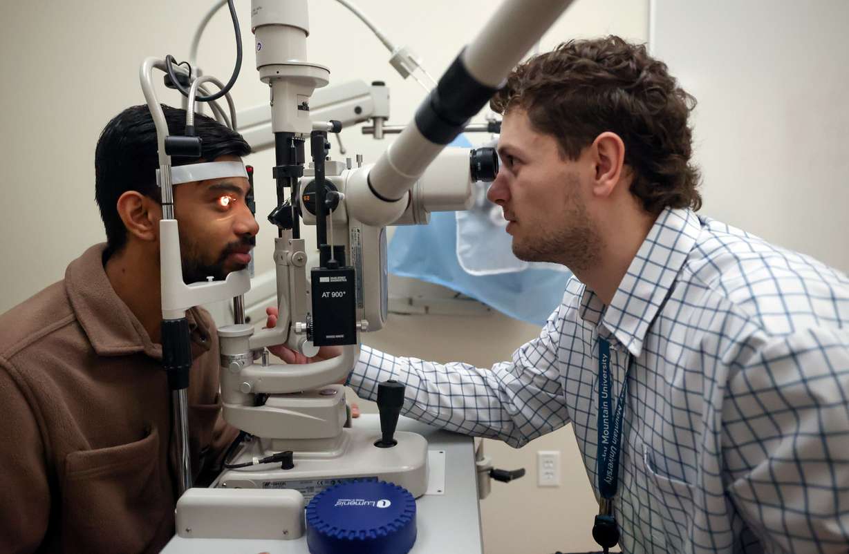 Second-year doctor of optometry student Coleby Hess, right, checks the cornea of fellow second-year student Parth Patel at Rocky Mountain University in Provo on Jan. 14.