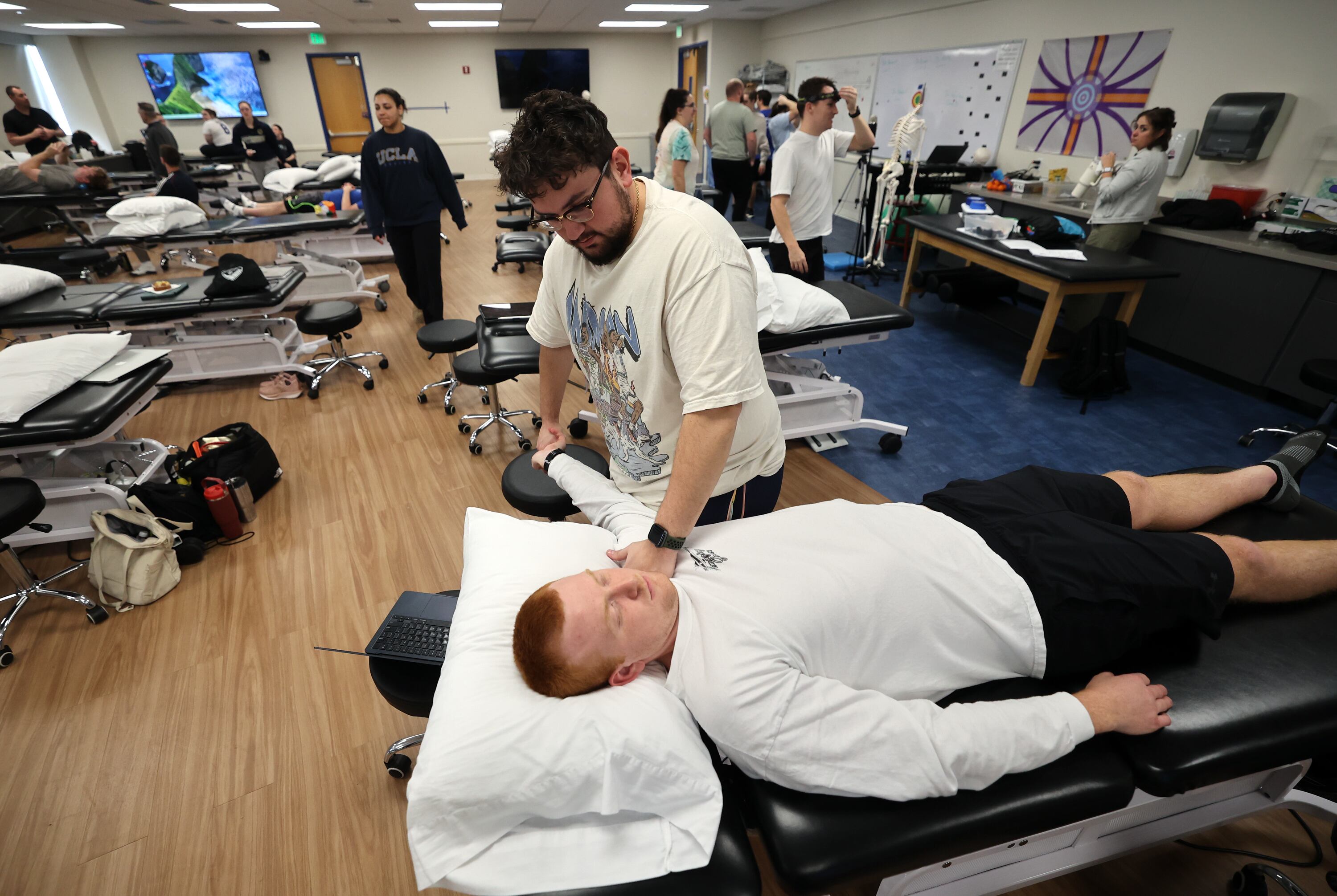 Second-year doctor of physical therapy student Kaden Kennard does upper limb nerve testing on fellow second-year student Kyle Watkins at Rocky Mountain University in Provo on Jan. 14.