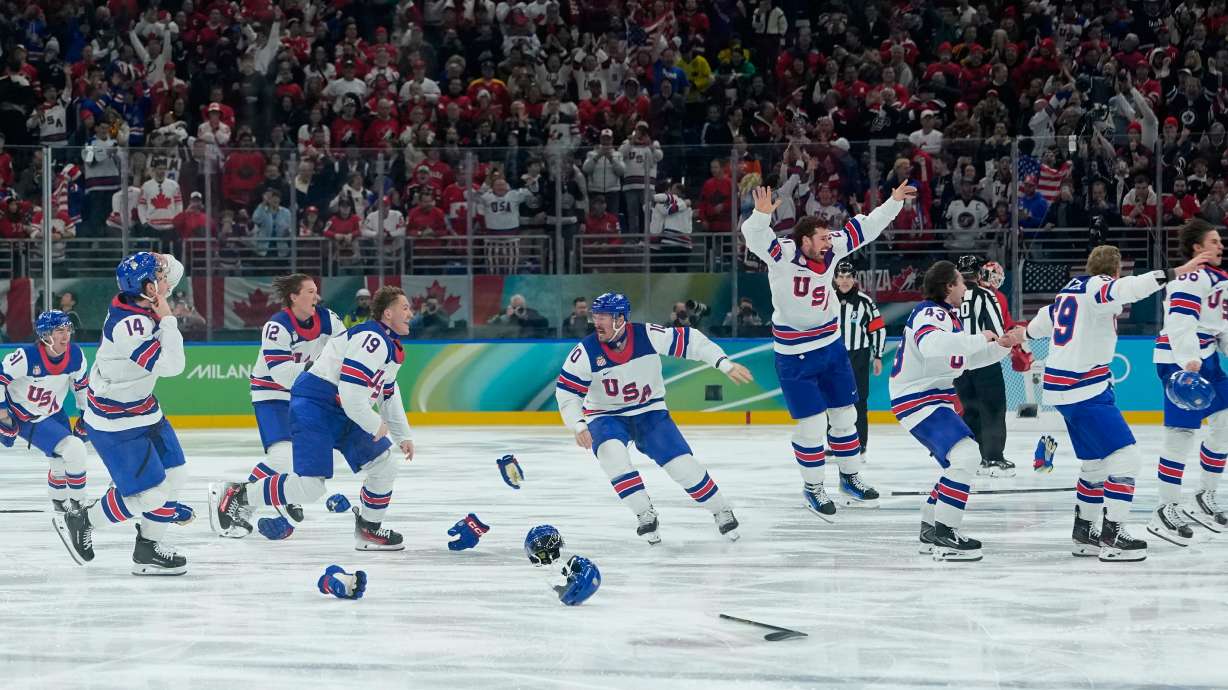 United States players celebrate after defeating Canada during a men's ice hockey gold medal game between Canada and the United States at the 2026 Winter Olympics, in Milan, Italy, Sunday, Feb. 22, 2026.