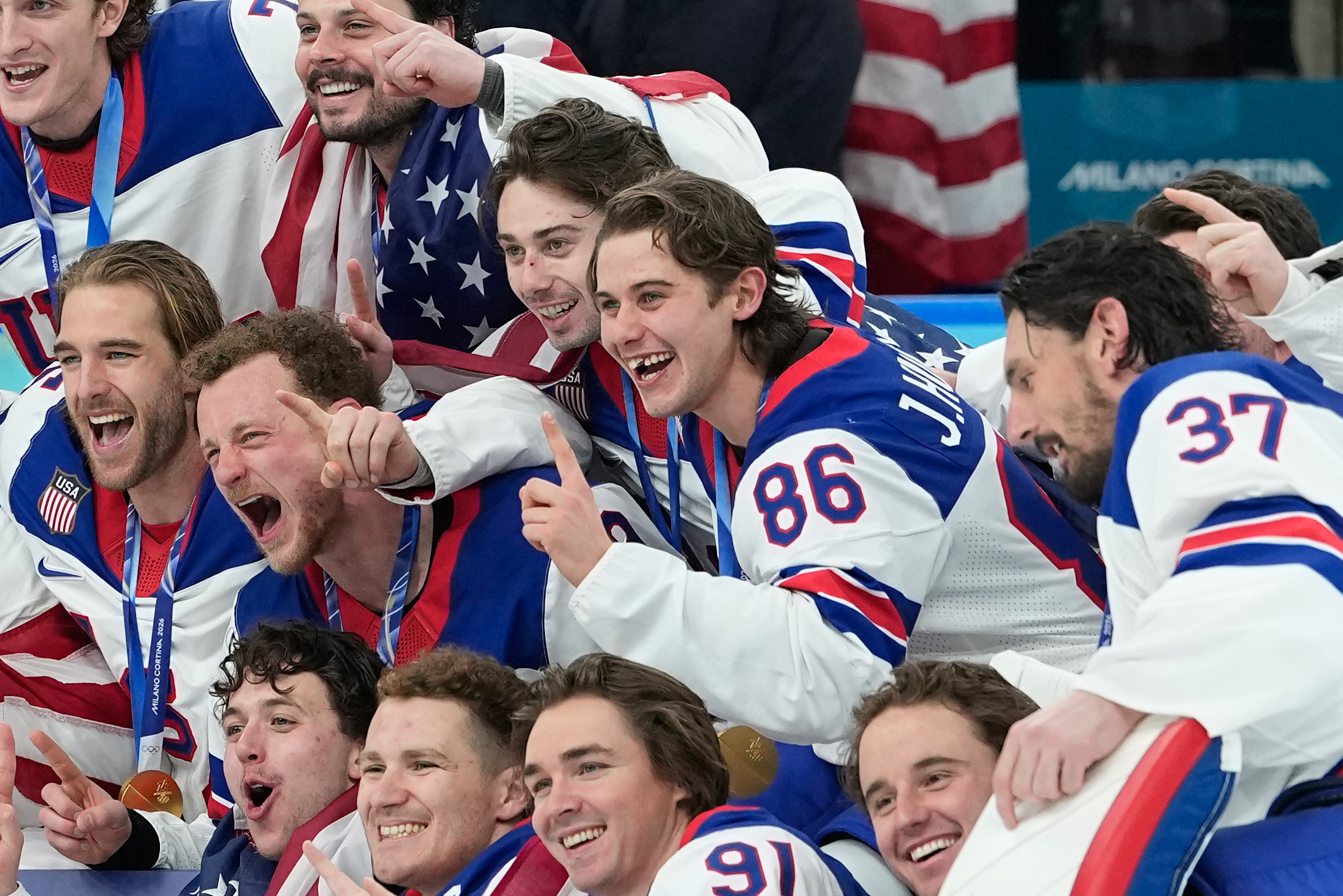 United States' Jack Hughes (86) poses with teammates after a men's ice hockey gold medal game between Canada and the United States at the 2026 Winter Olympics, in Milan, Italy, Sunday, Feb. 22, 2026. 