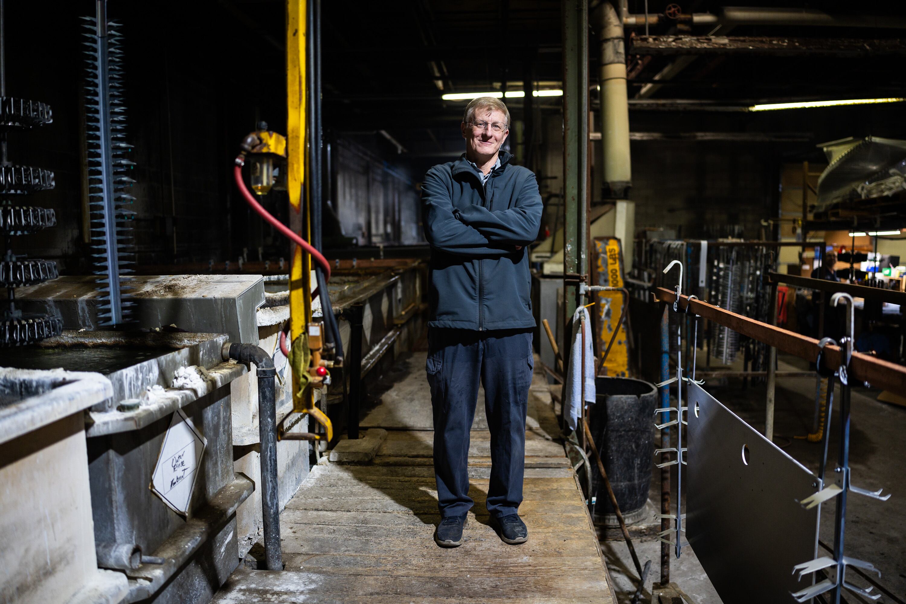Glenn Fassmann, owner and operator at Quality Plating Co. Inc., poses next to the anodizing line at Quality Plating Co. Inc.'s main plant in Salt Lake City on Feb. 4. The business is closing its doors in March.