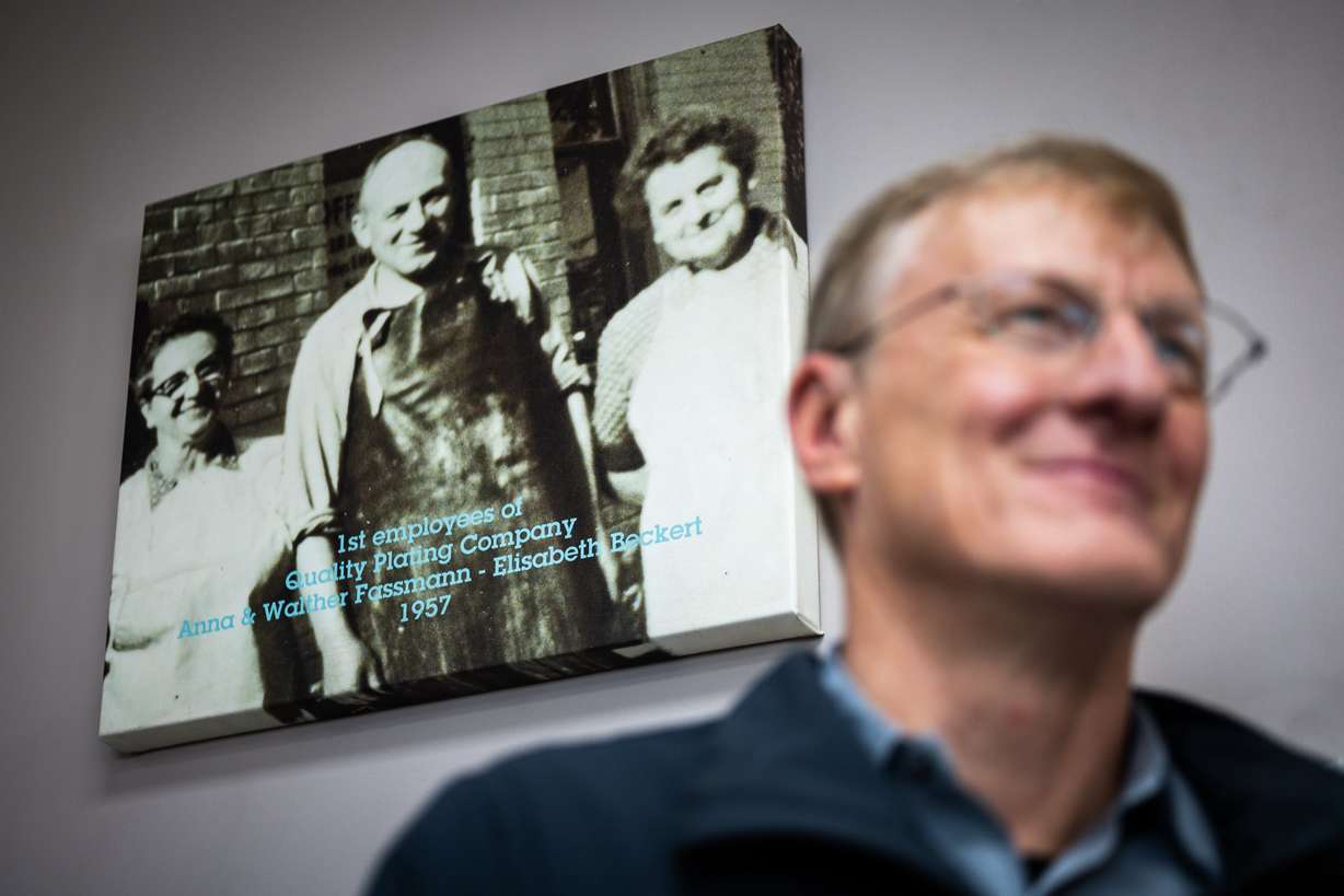 Glenn Fassmann, owner and operator at Quality Plating Co. Inc., next to a photo of his grandmothers, Anna Fassmann and Elisabeth Beckert, and his grandfather, Walther Fassmann, at Quality Plating Co. Inc.'s main plant in Salt Lake City on Feb. 4. The family business is closing its doors in March.