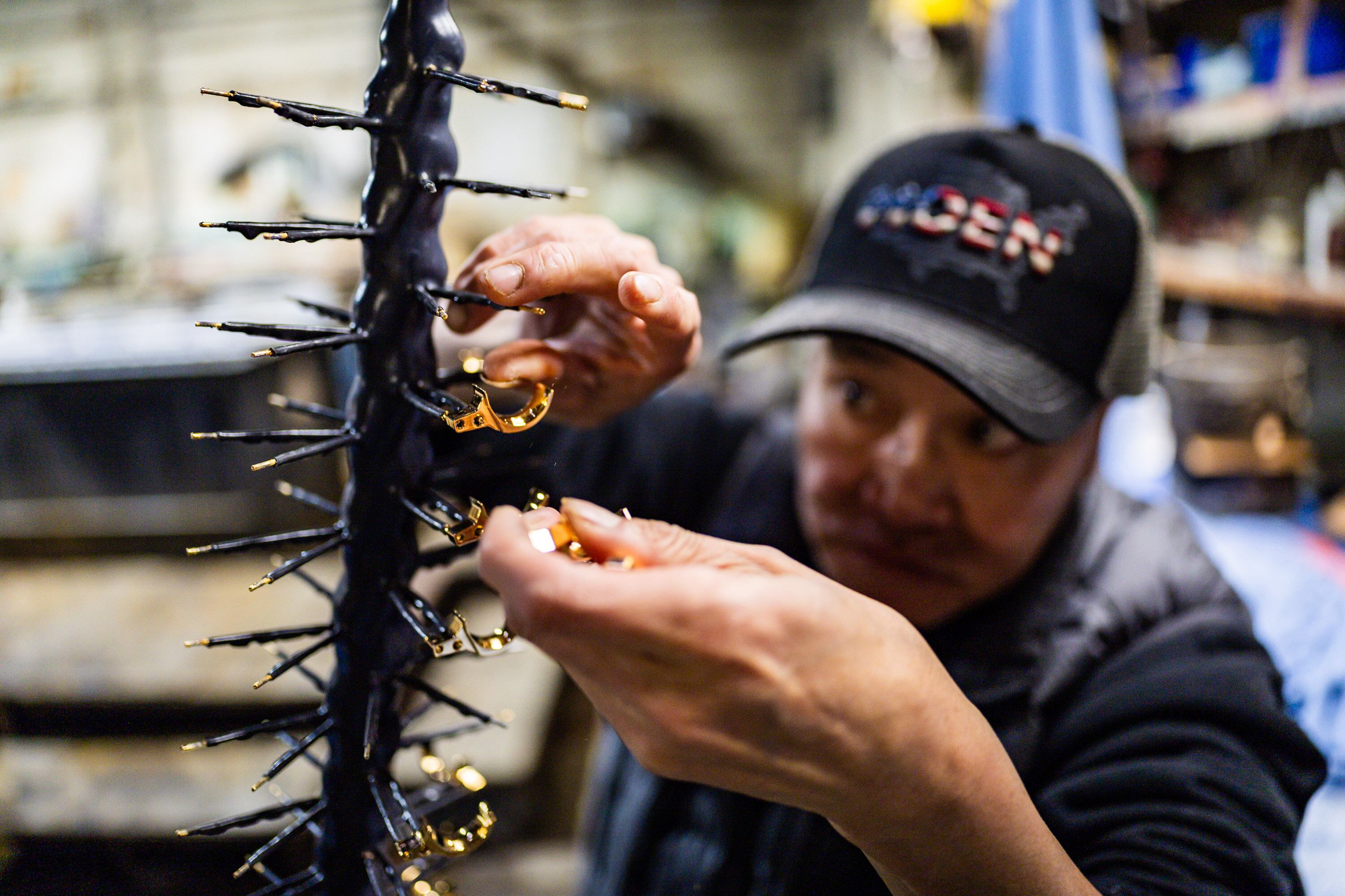 Tai Nguyen, an employee at Quality Plating Co. Inc., plates nickel triggers with gold at Quality Plating Co. Inc.’s main plant in Salt Lake City on Feb. 4. The business is closing its doors in March.