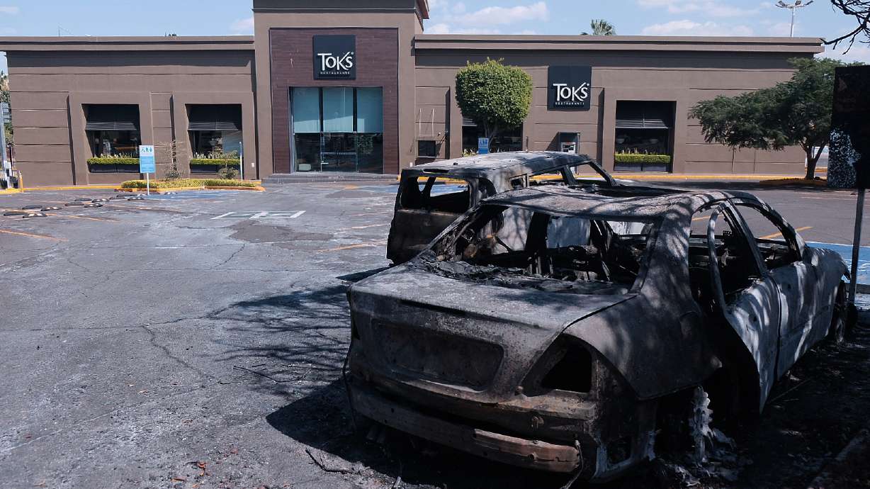 Charred vehicles sit in a parking lot sit outside a shopping mall in Guadalajara, Jalisco state, Mexico, Sunday, Feb. 22, 2026, as authorities reported that the Mexican Army killed Jalisco New Generation Cartel leader Nemesio Oseguera, known as "El Mencho."