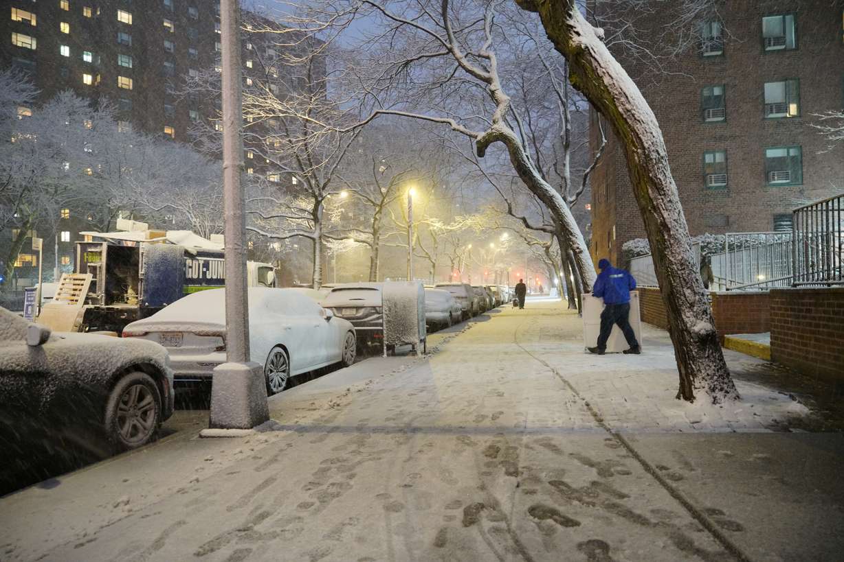 A man works in a snowstorm, Sunday, in New York.