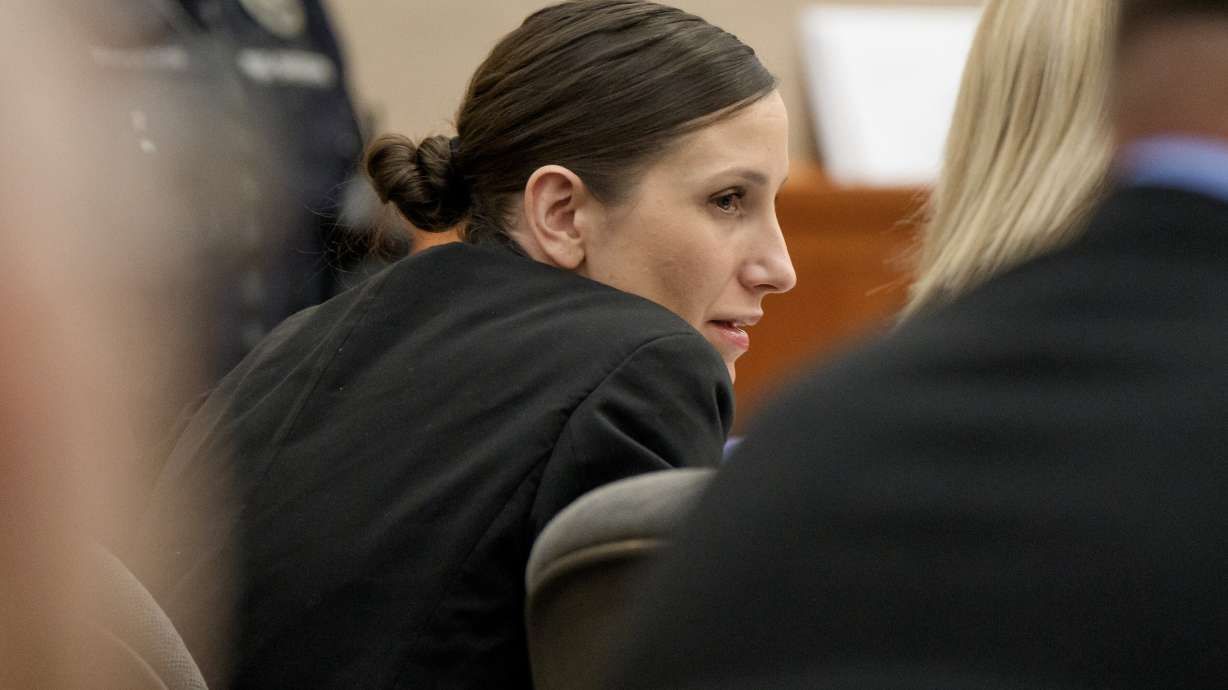 Kouri Richins, a Utah mother accused of fatally poisoning her husband, talks to her attorneys during her murder trial at the Summit County Courthouse on Monday