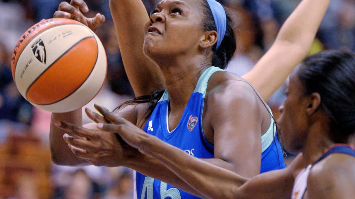 FILE - New York Liberty's Kara Braxton is fouled by Connecticut Sun's Kalana Greene during a WNBA exhibition basketball game, May 7, 2012, in Uncasville, Conn.
