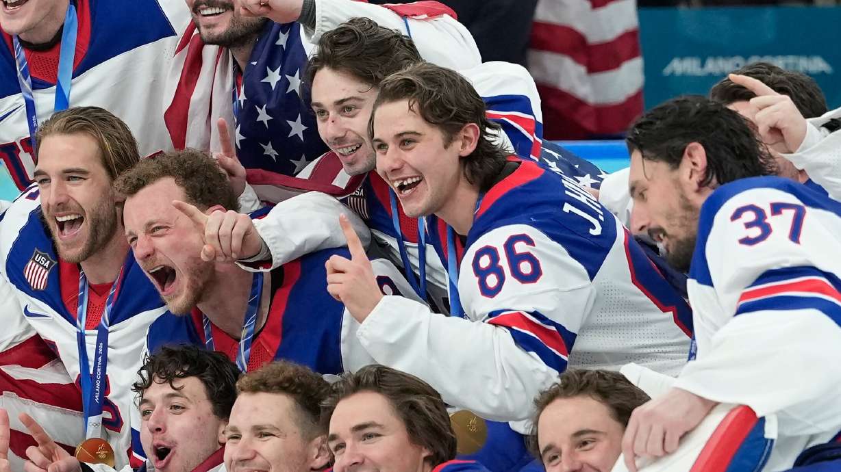 United States' Jack Hughes (86) poses with teammates after a men's ice hockey gold medal game between Canada and the United States at the 2026 Winter Olympics, in Milan, Sunday.