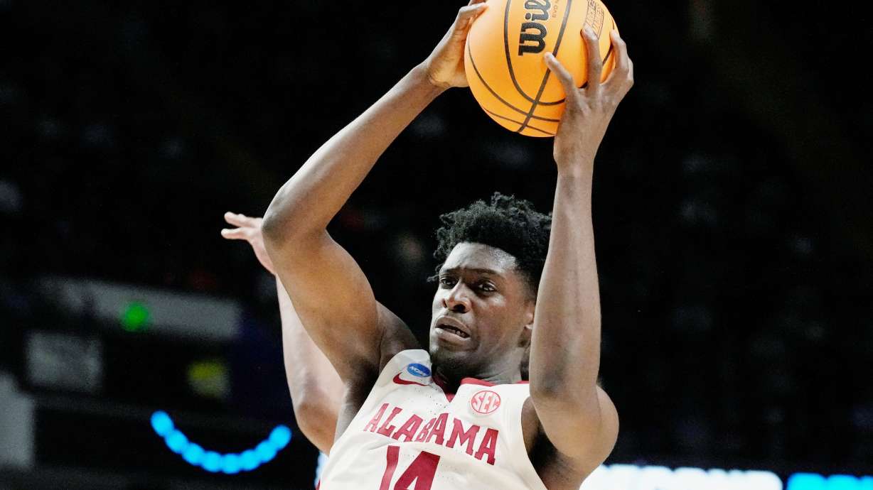 FILE - Alabama center Charles Bediako (14) pulls down a rebound while guarded by Maryland guard Ian Martinez, left, during the second half of a second-round college basketball game in the men's NCAA Tournament in Birmingham, Ala., March 18, 2023.