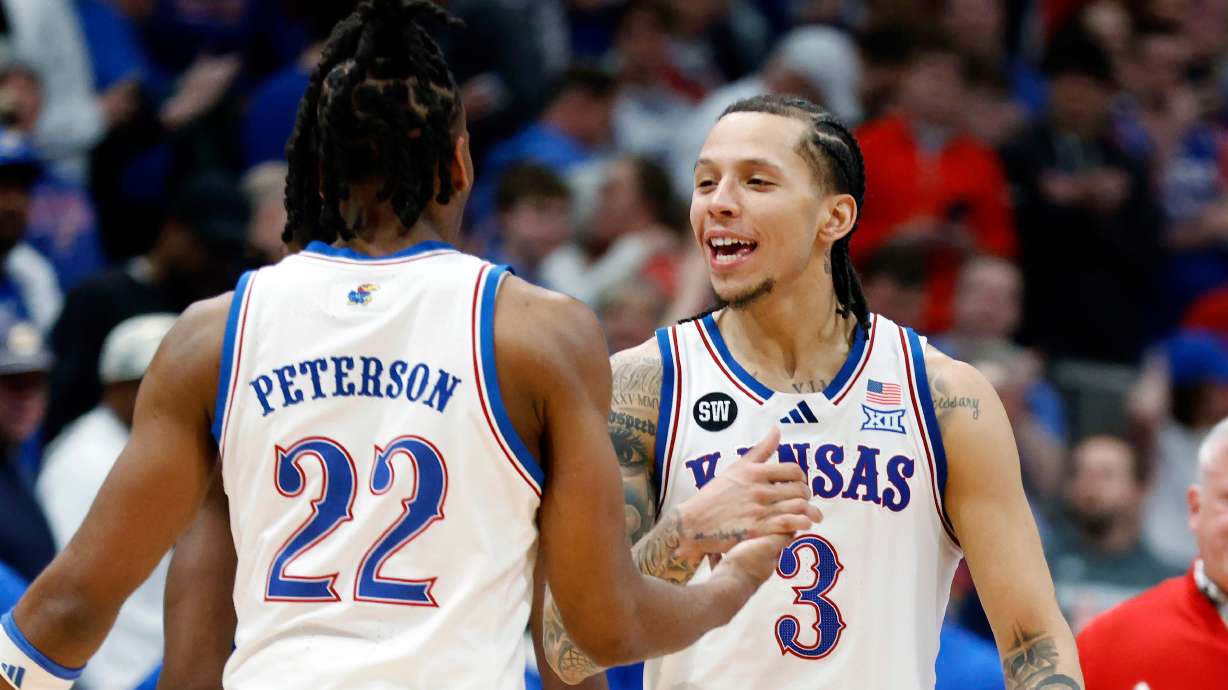 Kansas guards Tre White (3) and Darryn Peterson (22) celebrate after an NCAA college basketball game against Houston, Monday, Feb. 23, 2026, in Lawrence, Kan.