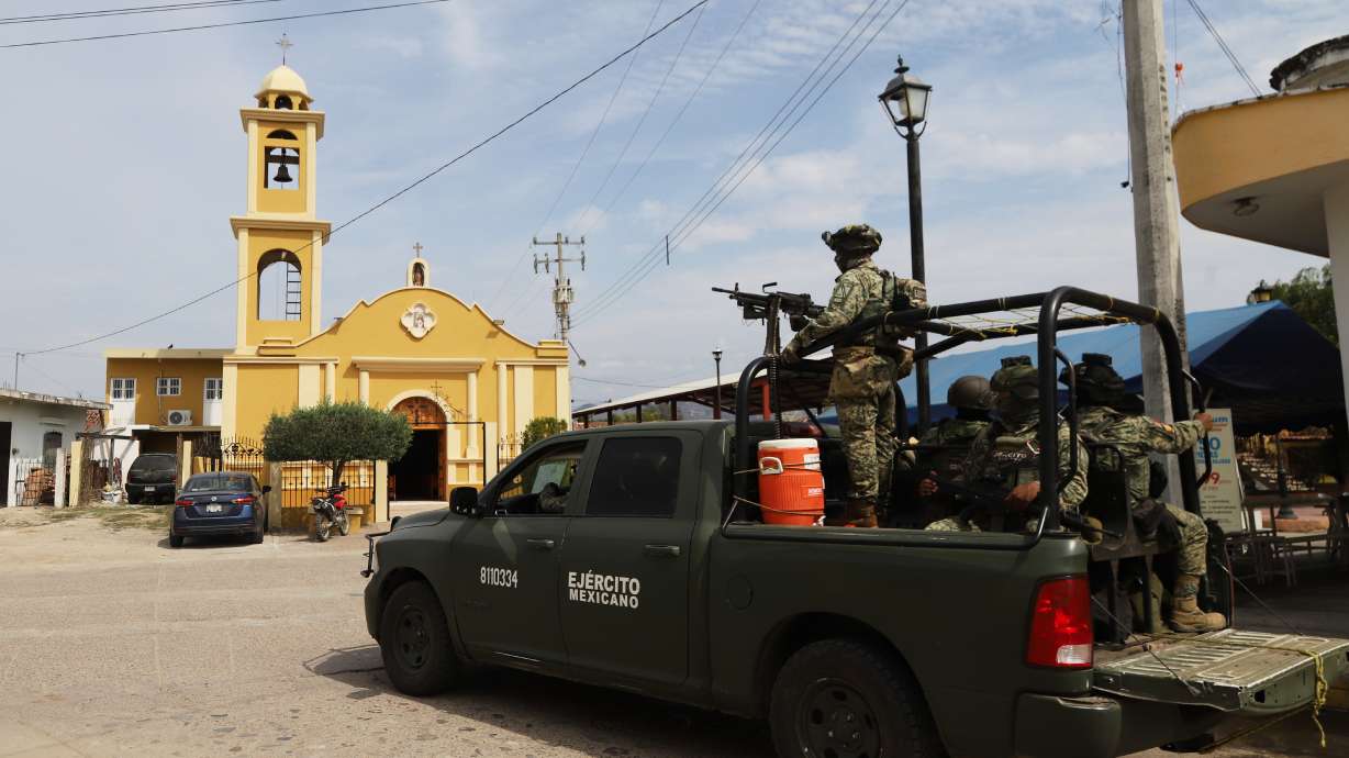 Soldiers stand guard near a church in El Verde, Sinaloa state, Mexico, Monday, Feb. 8, 2026.