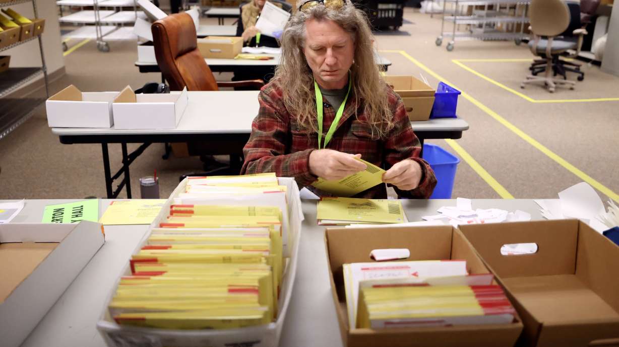 Jim Speer tabs ballots at the Salt Lake County Government Center in Salt Lake City on Oct. 31, 2024. Utah's congressional Republicans are carefully wading into the election reform debate.
