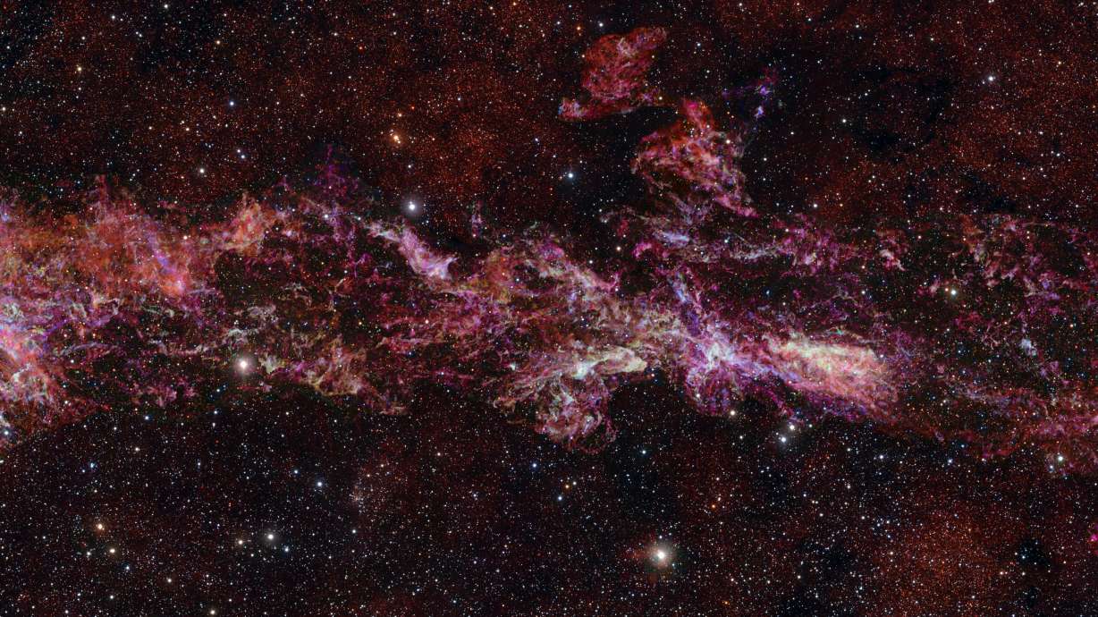 This image provided by the European Southern Observatory shows the complex distribution of molecular gas in the Central Molecular Zone of the Milky Way, designated in different colors: sulphur monoxide (cyan), silicon monoxide (green), isocyanic acid (red), cyanoacetylene (blue), and carbon monosulphide (magenta). The stars in the foreground of this image were observed at infrared wavelengths (Y, Z and J filters).