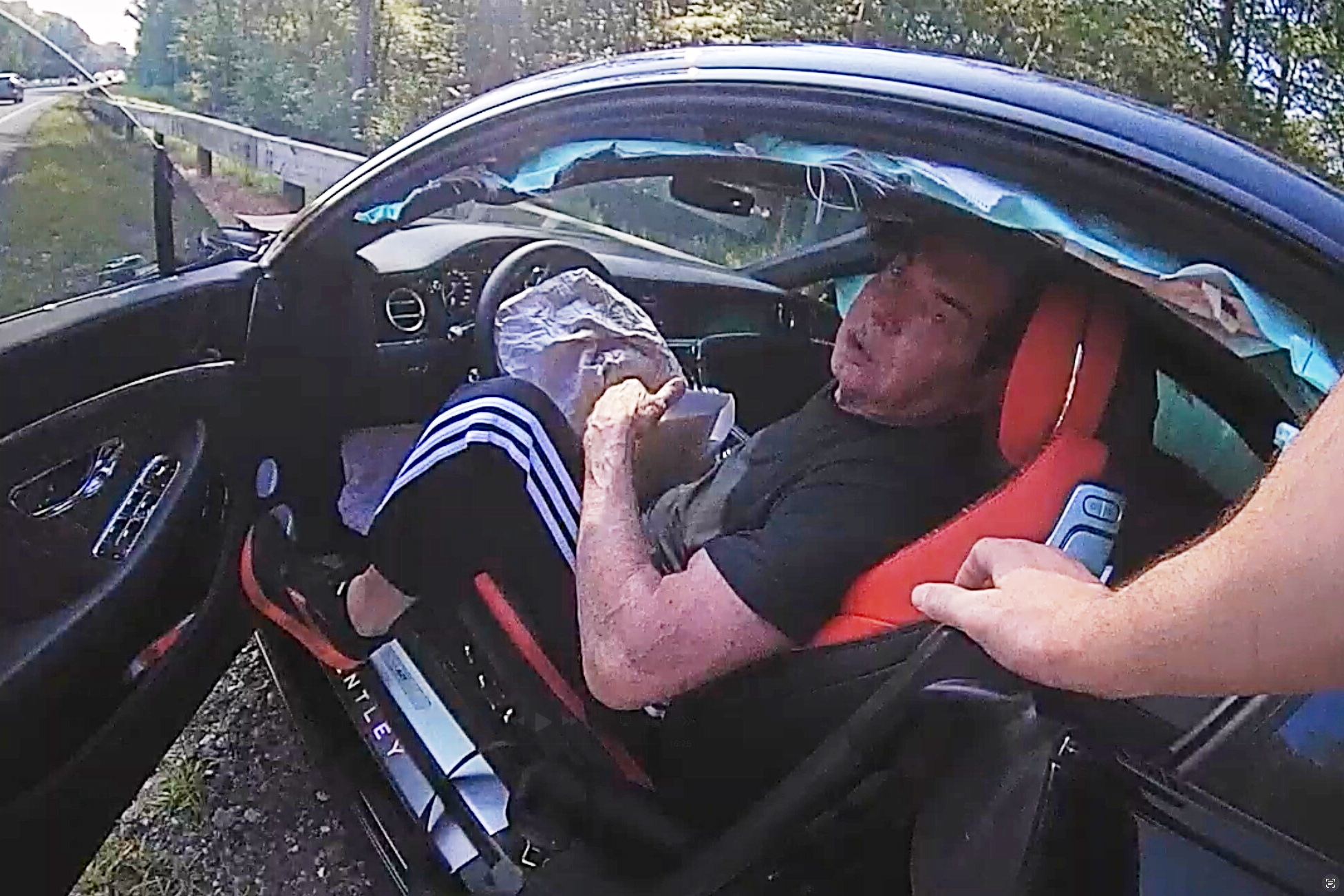 In an image taken from Connecticut State Police police bodycam video, Vince McMahon is questioned in his car after an accident on July 24, 2025, in Westport, Conn. 