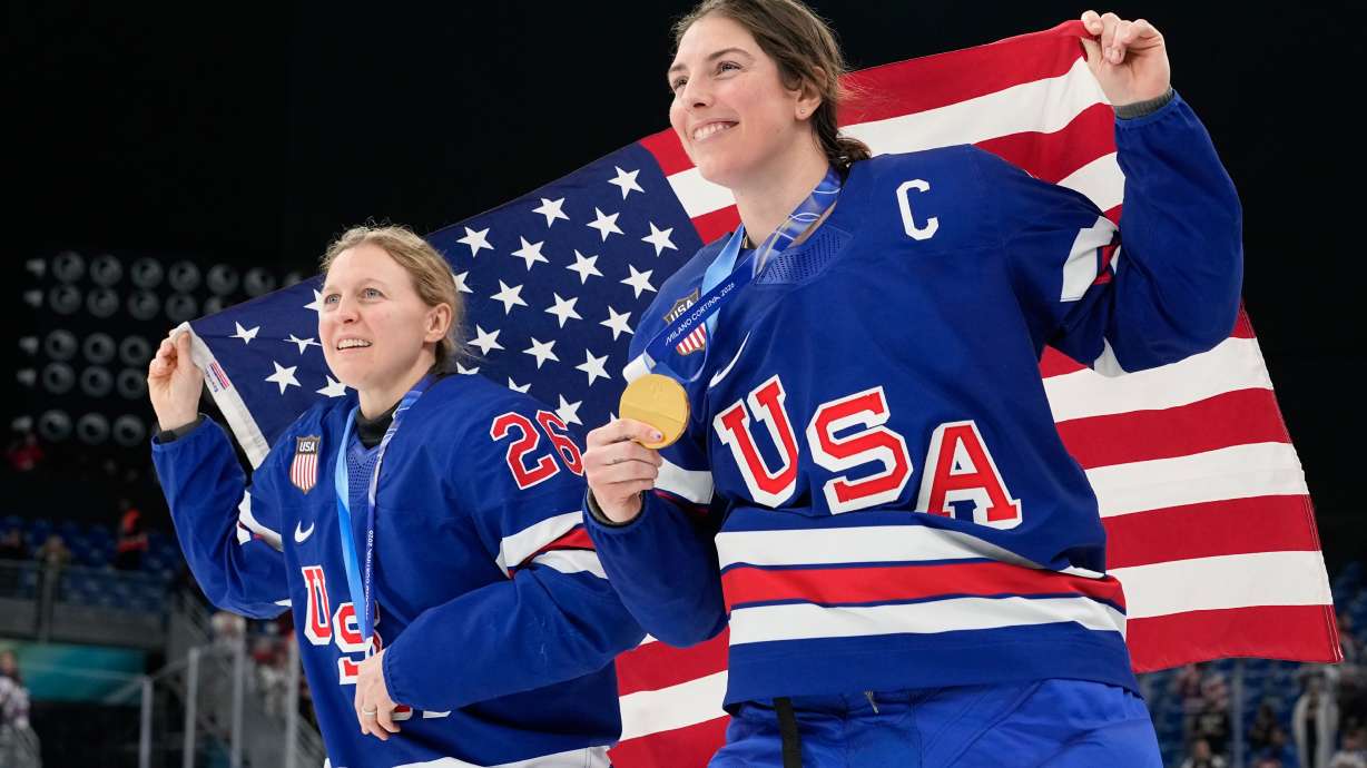 United States' Kendall Coyne, left, and United States' Hilary Knight celebrate after victory ceremony for women's ice hockey at the 2026 Winter Olympics, in Milan, Italy, Thursday, Feb. 19, 2026.