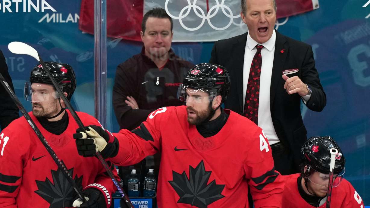 Canada head coach Jon Cooper, top right, directs his players during the first period of the men's ice hockey gold medal game against the United States at the 2026 Winter Olympics in Milan, Italy, Sunday, Feb. 22, 2026.