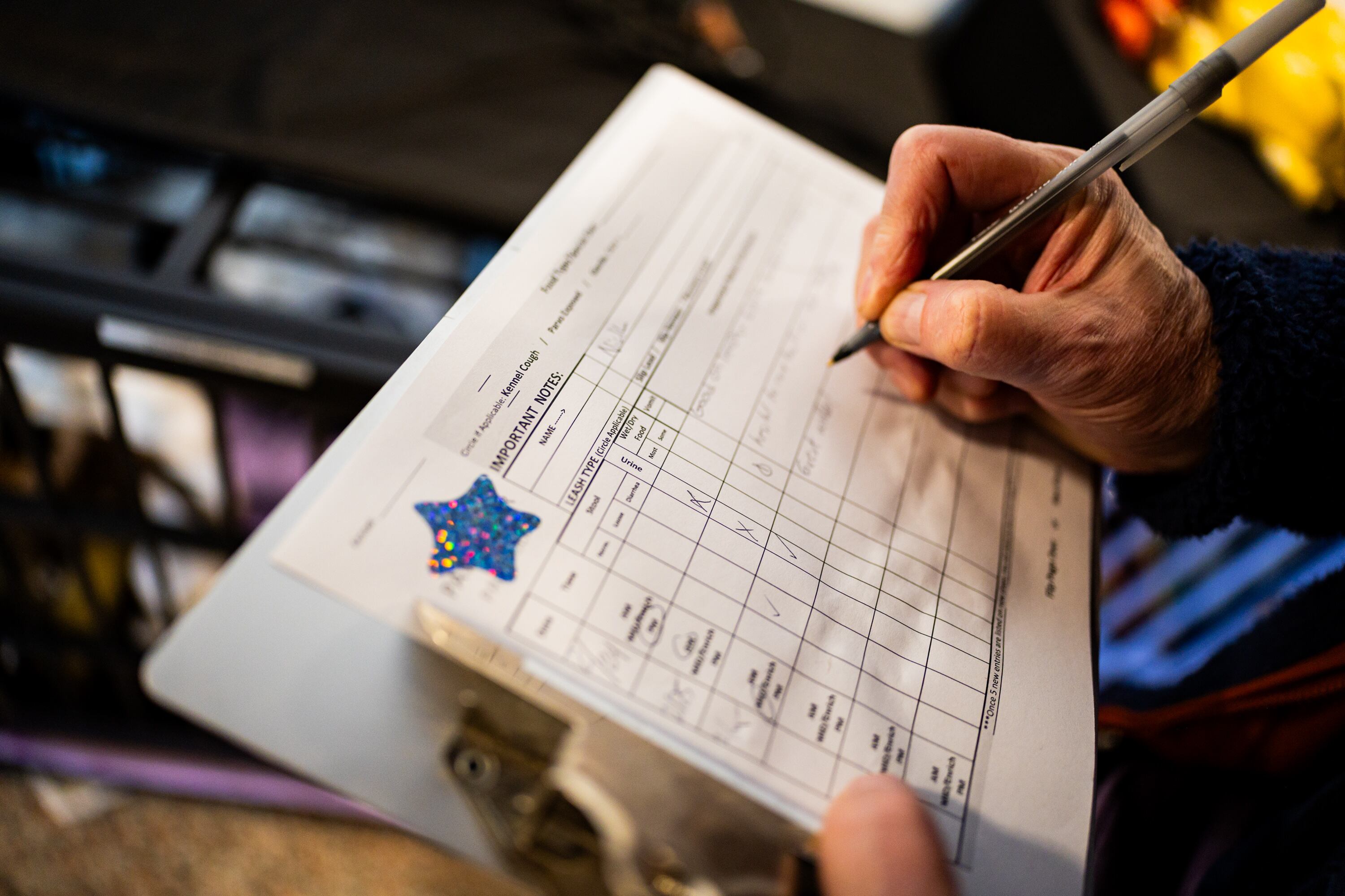 Lars Tatom, volunteer with the Best Friends Animal Society, takes notes after taking dog Nick on a walk at the Best Friends Animal Society in Salt Lake City on Wednesday. Utah lawmakers are working on legislation to aid shelter animals.