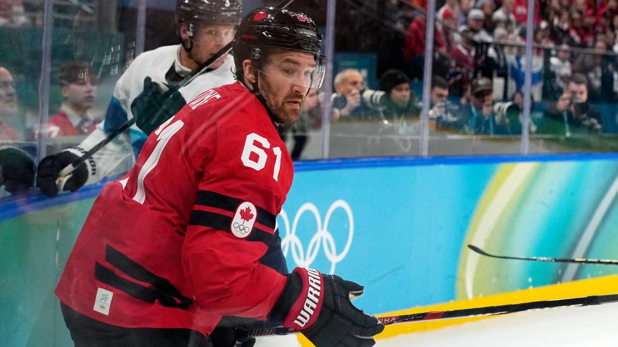 Canada's Mark Stone (61) challenges with Finland's Olli Maatta (3) during a men's ice hockey semifinal game between Canada and Finland at the 2026 Winter Olympics, in Milan, Italy, Friday, Feb. 20, 2026.
