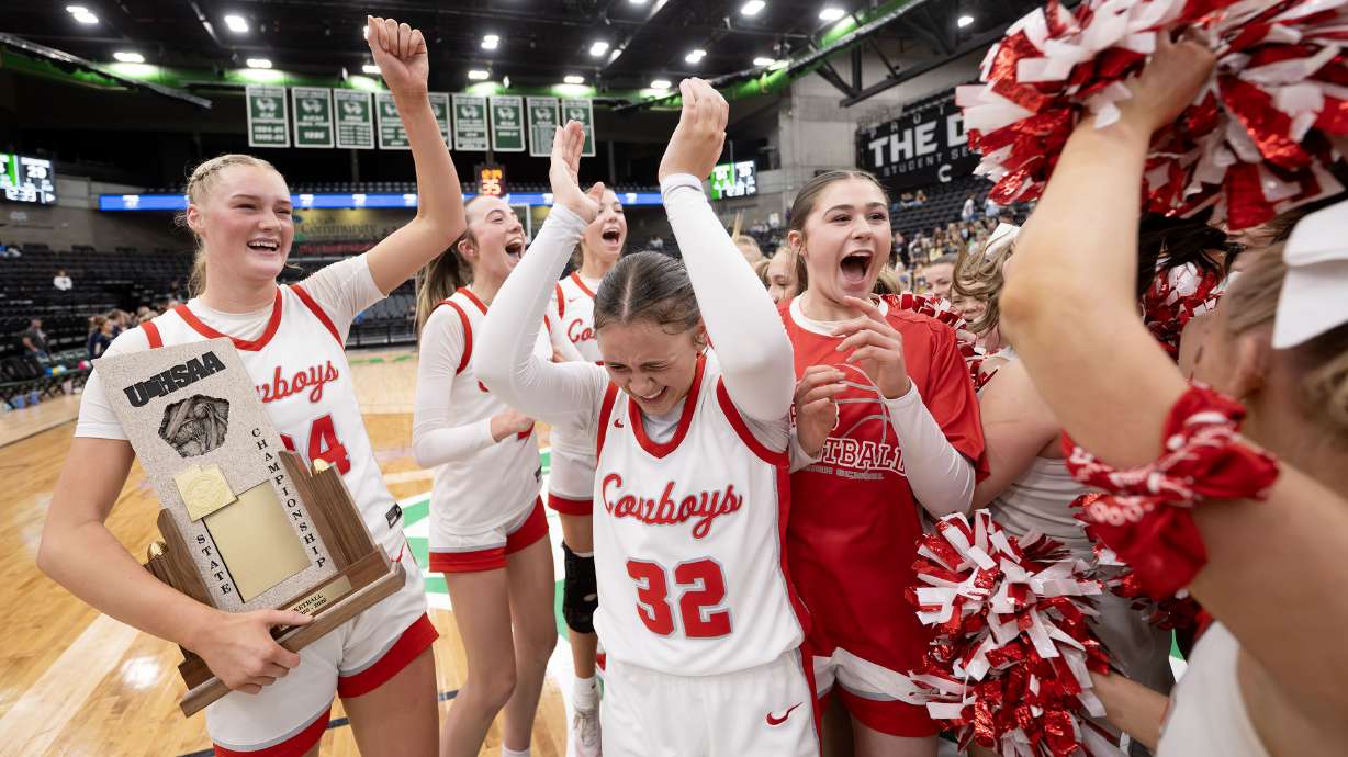 Kanab’s Rylee Little holds the championship trophy as she and her teammates celebrate defeating Enterprise for the 2A basketball state championship at UVU’s UCCU Center in Orem, on Thursday, Feb. 25, 2026.