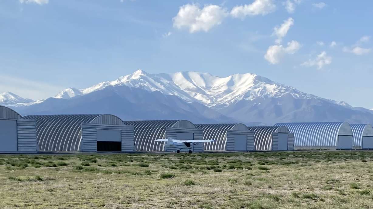 A small plane taxis by hangars at the West Desert Airpark in Fairfield, Utah County.