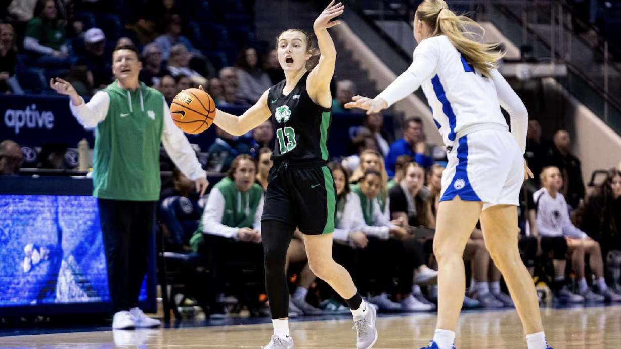 Utah Valley University guard Ally Criddle (13) calls out to her teammates as she brings the ball up the court while guarded by Brigham Young University guard Brinley Cannon (24) during an NCAA women’s basketball game between the BYU Cougars and the UVU Wolverines held at the Marriott Center in Provo on Dec. 10, 2024.
